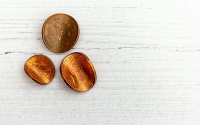 On the left are three squished pennies, to symbolize corruption.