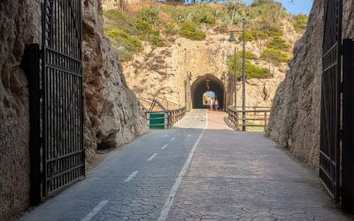 Looking out of a stone tunnel at a road ahead